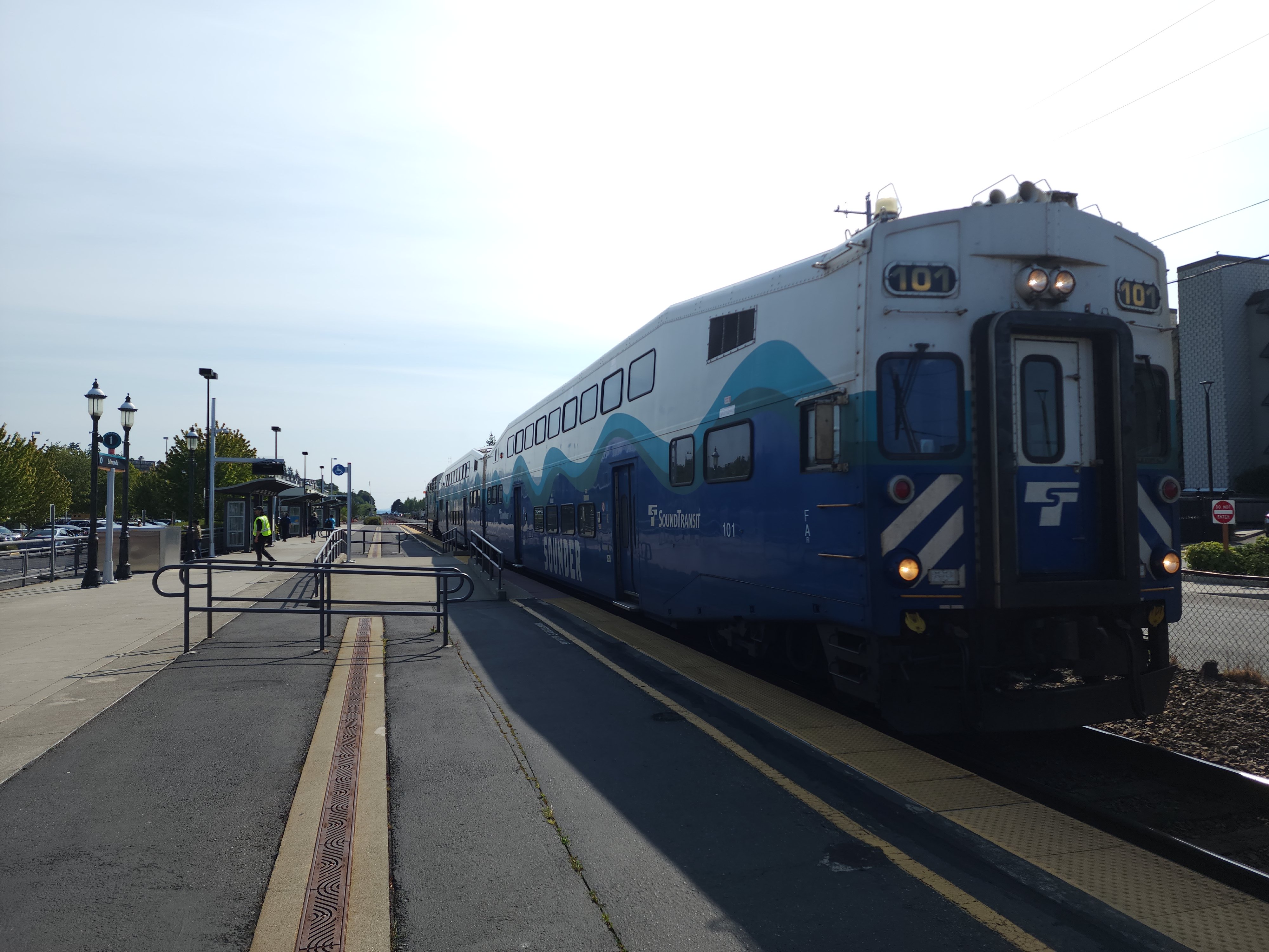 The Sound Transit Sounder train sitting at the Edmonds Station. The back of the train is visible, with a cab car that is very similar to a regular coach car but with a small driver's compartment off to the side of the end door.